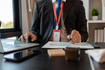 a businessman is reviewing accounting and financial statistics documents in his private office, the statistician prepares various charts and documents for a meeting