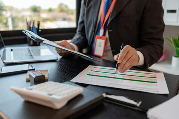 a businessman is reviewing accounting and financial statistics documents in his private office, the statistician prepares various charts and documents for a meeting
