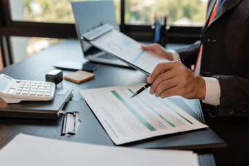 a businessman is reviewing accounting and financial statistics documents in his private office, the statistician prepares various charts and documents for a meeting