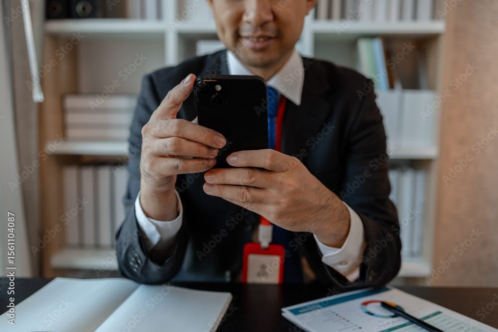 Poster a businessman woks with a foreign company and uses a smartphone to help send and receive information