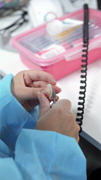Dental prosthesis in the hands of the doctor close-up. Dentist holding ceramic dental bridge. Front view of complete denture. Dentistry conceptual photo. Prosthetic dentistry. False teeth