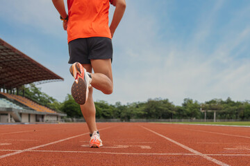 Athlete Running on Track Field in Stadium