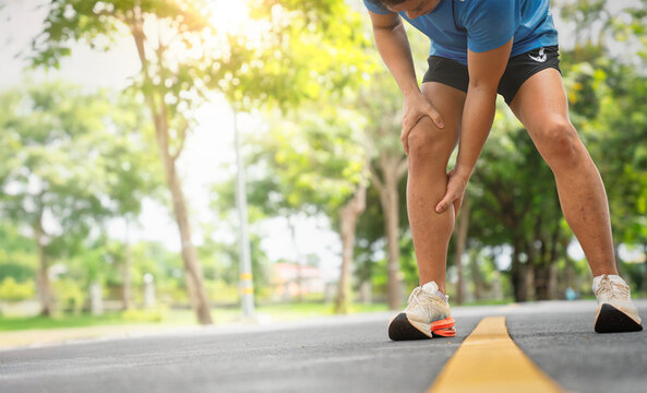 Runner Leaning Over with Leg Discomfort During Jog