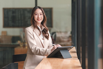 Professional woman engaging with digital tablet in modern office environment for enhanced productivity and collaboration