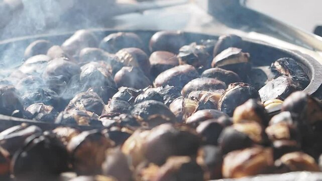 Cooking delicious roasted chestnuts in a bustling market