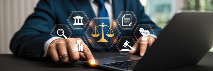 Businessperson using a laptop with legal icons superimposed.