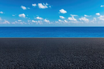 Obraz premium Empty asphalt road leading to the ocean under a cloudy sky, offering a scenic view of freedom and travel