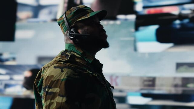 African american trooper keeping in touch with the mission control tower, collecting crucial satellite information through imagery. Transmitting important territorial data. Camera B.