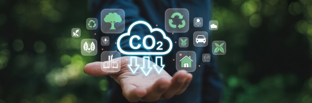 Hand displaying a digital interface of co2 reduction icons. - Powered by Adobe