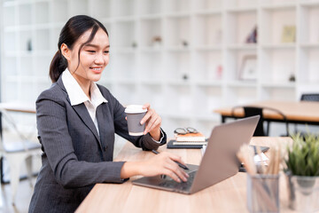 Portrait of smiling businesswoman sitting at desk in the office