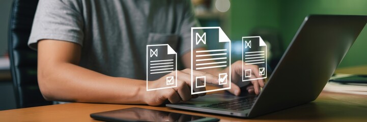 Person reviewing documents on a laptop.