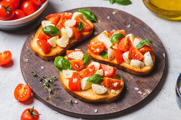 Bruschetta caprese with cherry tomatoes and mozzarella garnished with basil