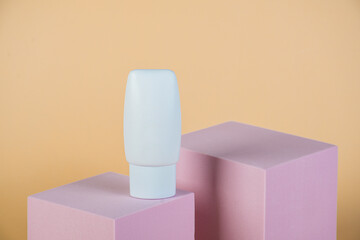 Plastic white tube for cream or lotion. Skin care or sunscreen cosmetic with stylish props on cream...