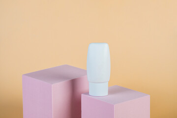 Plastic white tube for cream or lotion. Skin care or sunscreen cosmetic with stylish props on cream...