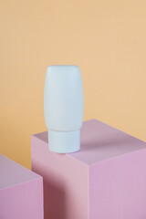Plastic white tube for cream or lotion. Skin care or sunscreen cosmetic with stylish props on cream...