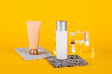 Plastic white tube for cream or lotion. Skin care or sunscreen cosmetic with stylish props on...