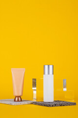 Plastic white tube for cream or lotion. Skin care or sunscreen cosmetic with stylish props on...