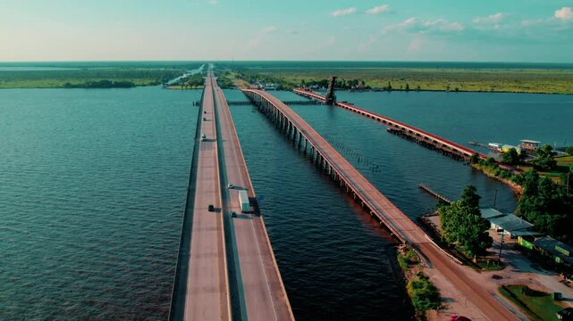 I-55 twin bridge system through Manchac Swamp near Akers, LA, with truck traffic and surrounding wetlands.