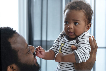 African father plays with his child son happily. Father's Day