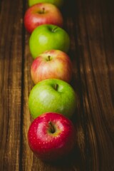 Red and green apples on table