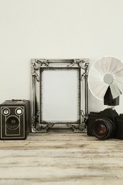 Photo frame, speaker and camera on table