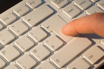 Finger pressing enter key