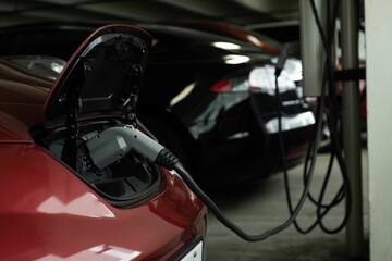 Electric car being charged at charging station