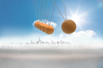 Newtons cradle above city in desert
