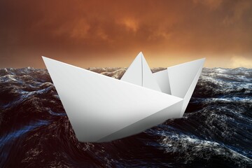 Paper boat floating on the sea