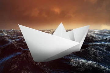 Gardinen Paper boat floating on the sea © vectorfusionart