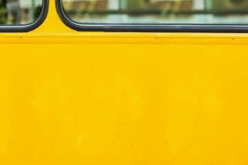 Flat design is showing yellow bus side with black-trimmed windows and rivets revealing greenery