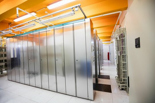 Fototapeta Server racks featuring cable trays, fluorescent lights, patch panel and extinguisher, flat design