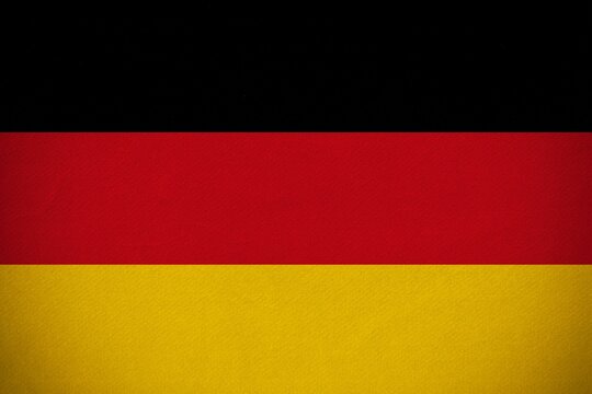 German flag is being displayed in flat design with fabric texture filling entire frame, copy space
