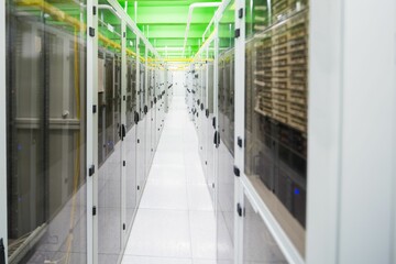 Flat-design corridor featuring white server racks, glass doors, overhead green trays with cables