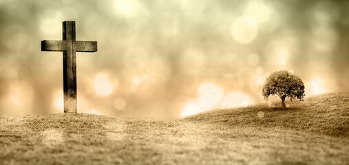 Flat design wooden cross and tree are standing on grassy hill under warm golden bokeh light