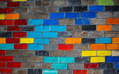 The brick wall is lined with multi-colored bricks.