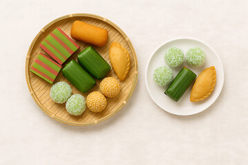 Traditional Indonesian Snack Assortment with Onde-onde, Klepon, and Lapis Cake on White and Natural Background