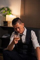 Bartender is pouring whiskey into a glass a customer's glass.	