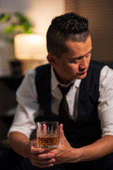 Bartender is pouring whiskey into a glass a customer's glass.	
