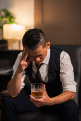 Bartender is pouring whiskey into a glass a customer's glass.	
