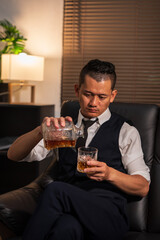 Bartender is pouring whiskey into a glass a customer's glass.	
