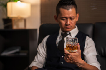 Bartender is pouring whiskey into a glass a customer's glass.	
