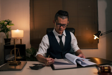 Lawyers are sitting in a meeting, searching for legal documents at the office.	
