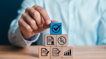 Hand placing blue cube check mark on wooden blocks image
