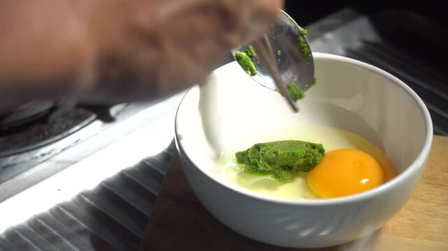 Chef cooking Super food. An omelet with Wolffia globosa, the nutrient rich plant. High quality plant protein, omega 3 and vital minerals. 