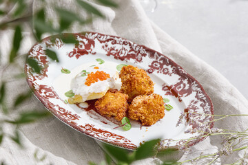 Halibut fillet with caviar sauce and potato croquettes, bright natural light, overhead plate...