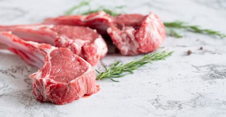 Raw lamb ribs with rosemary on a plate