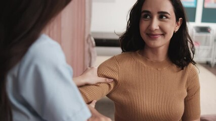 Hispanic female patient is hand stretching, treated for health recovery for muscle pain relief by a physical therapist doctor, passive medical therapy at spa clinic, and wellness massaging healthcare.