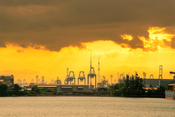 Industry landscape on sunset Engineering shipping crane depot at logistic export terminal control....
