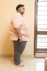 Overweight obese indian man standing. Profile Side view of Plus size fat guy. Obesity and weight loss.concept.